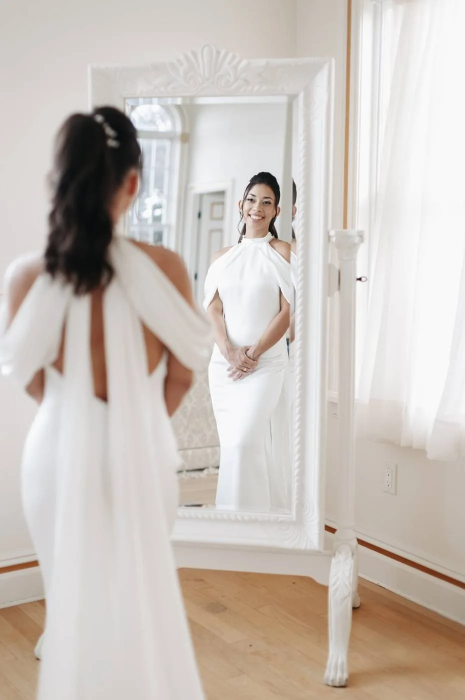 A bride in the mirror of the bright Bridal Suite