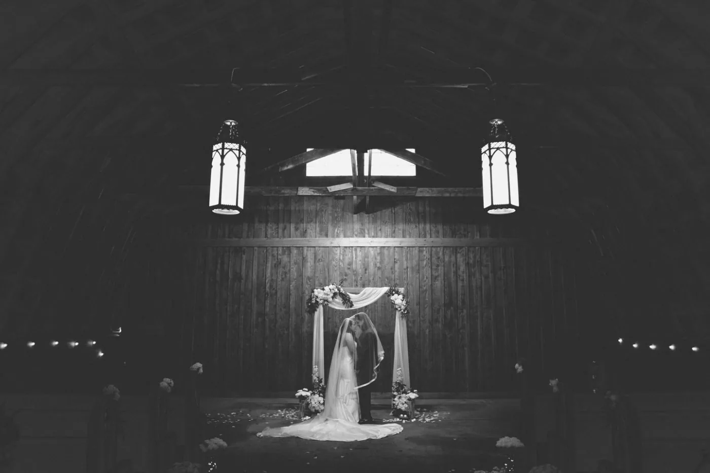A candlelit barn ceremony under lanterns