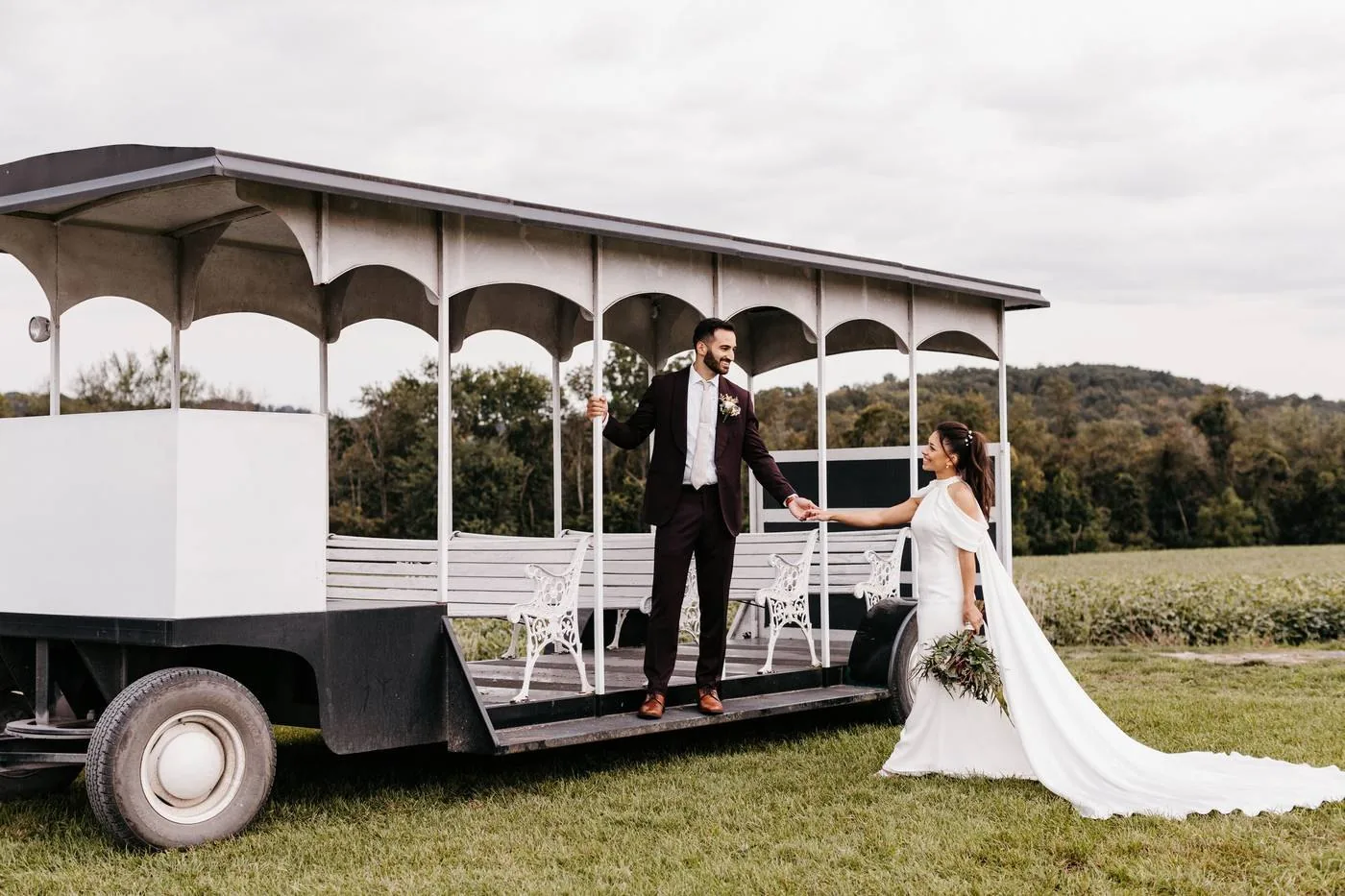 A couple on the open-air trolley in front of the fields