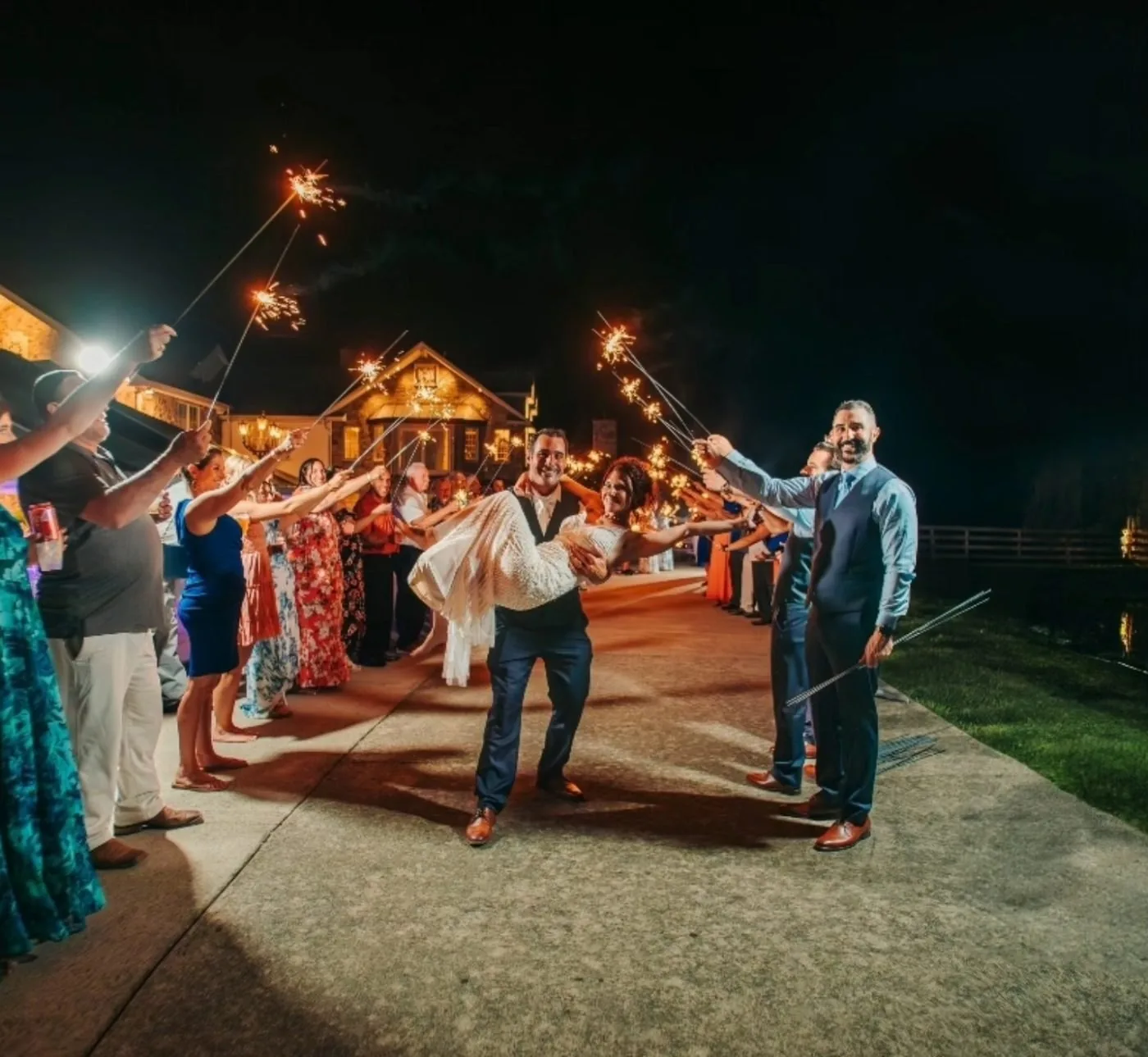 A sparkler send-off at night in front of the mansion